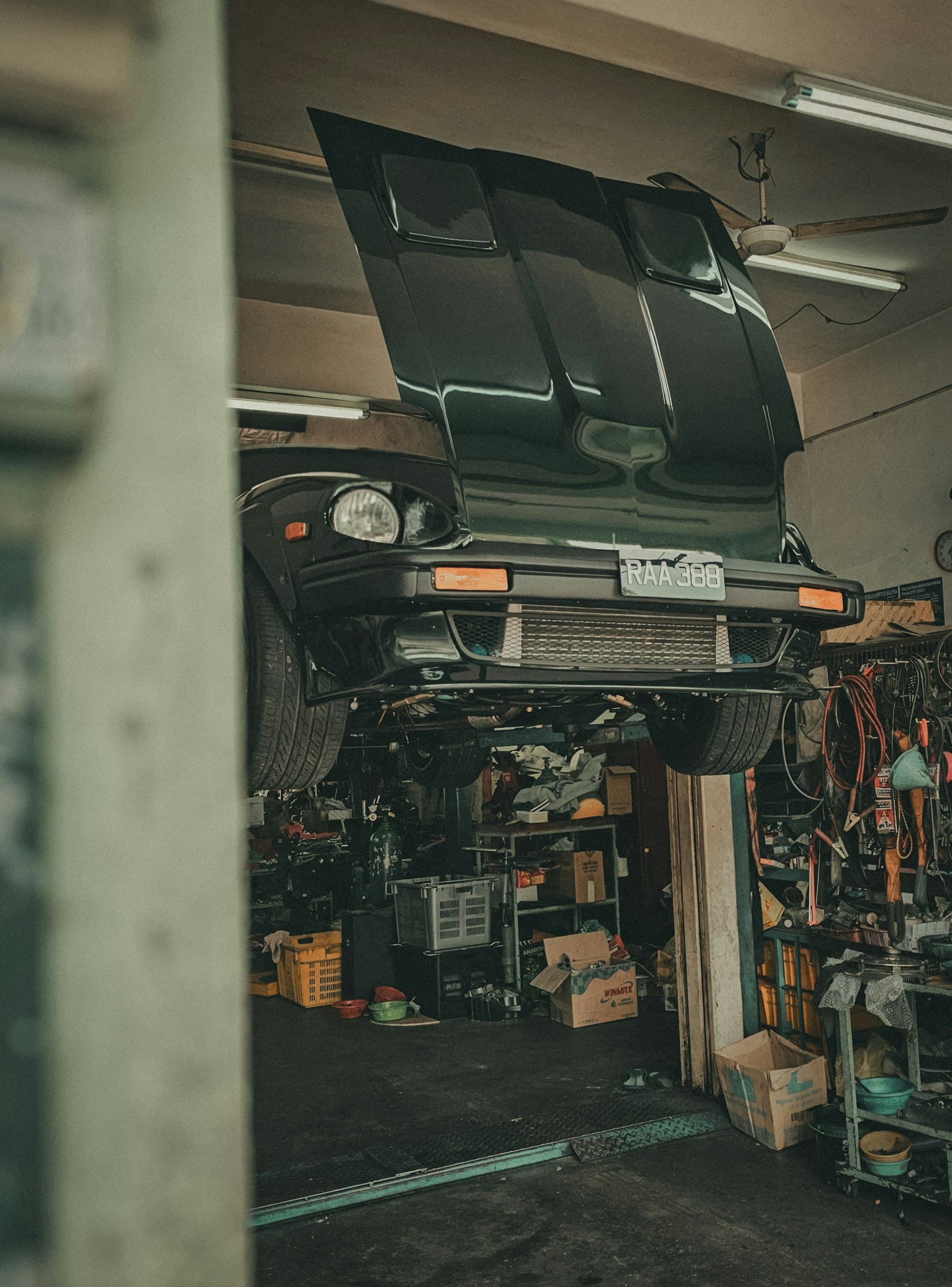 The underside of a car raised on a two post hoist
