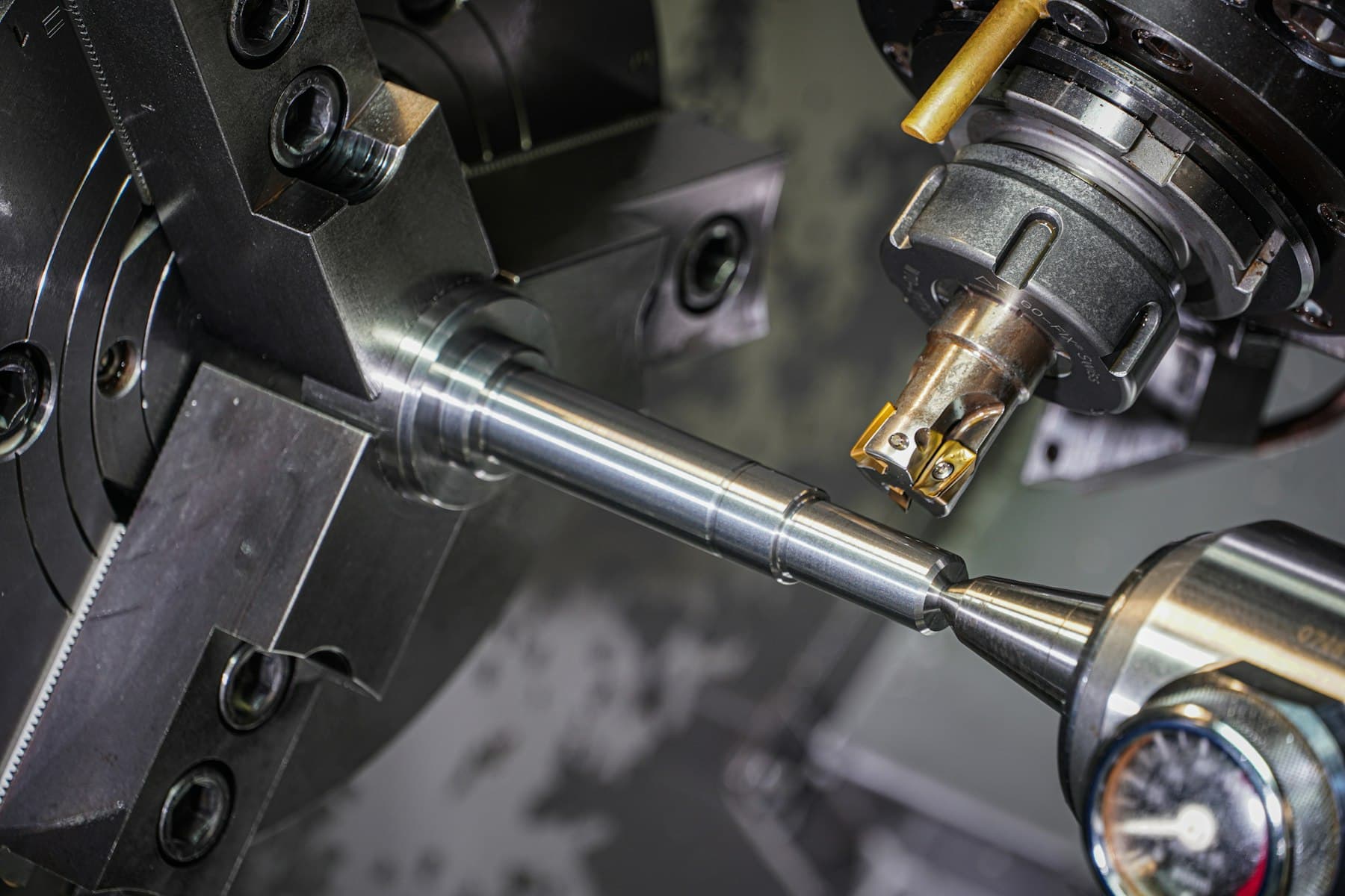 A metal component being cut in a lathe