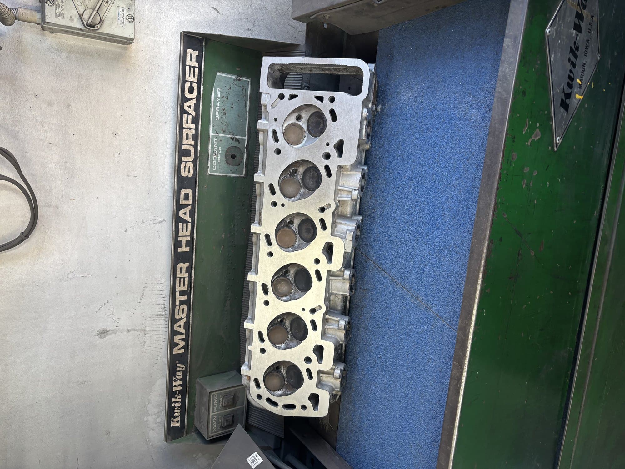 A cylinder head mounted on the Kwik-Way head surfacer at the Nerang workshop