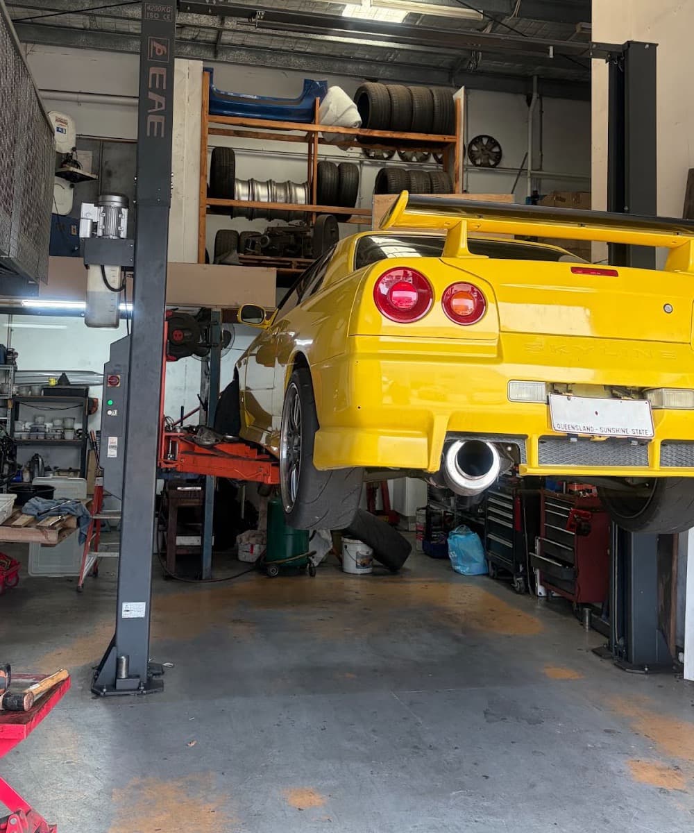 Inside the Fastbrake workshop in Nerang, tyres racked and a car on the hoist