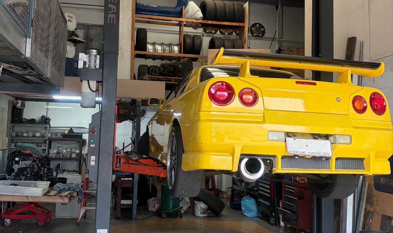 A car raised on the two post hoist inside the Fastbrake workshop in Nerang